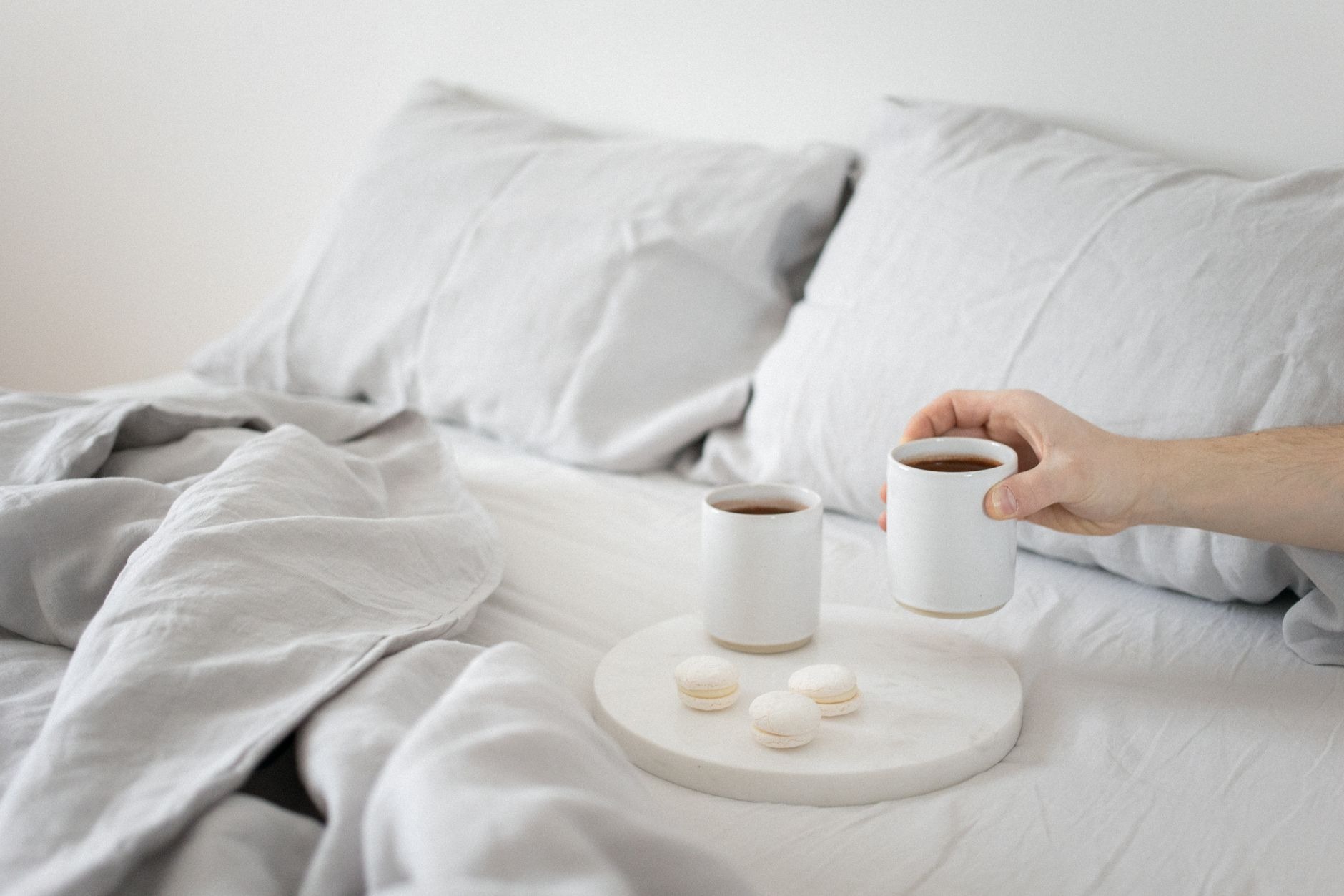 Guest room bed with fresh linens and morning light