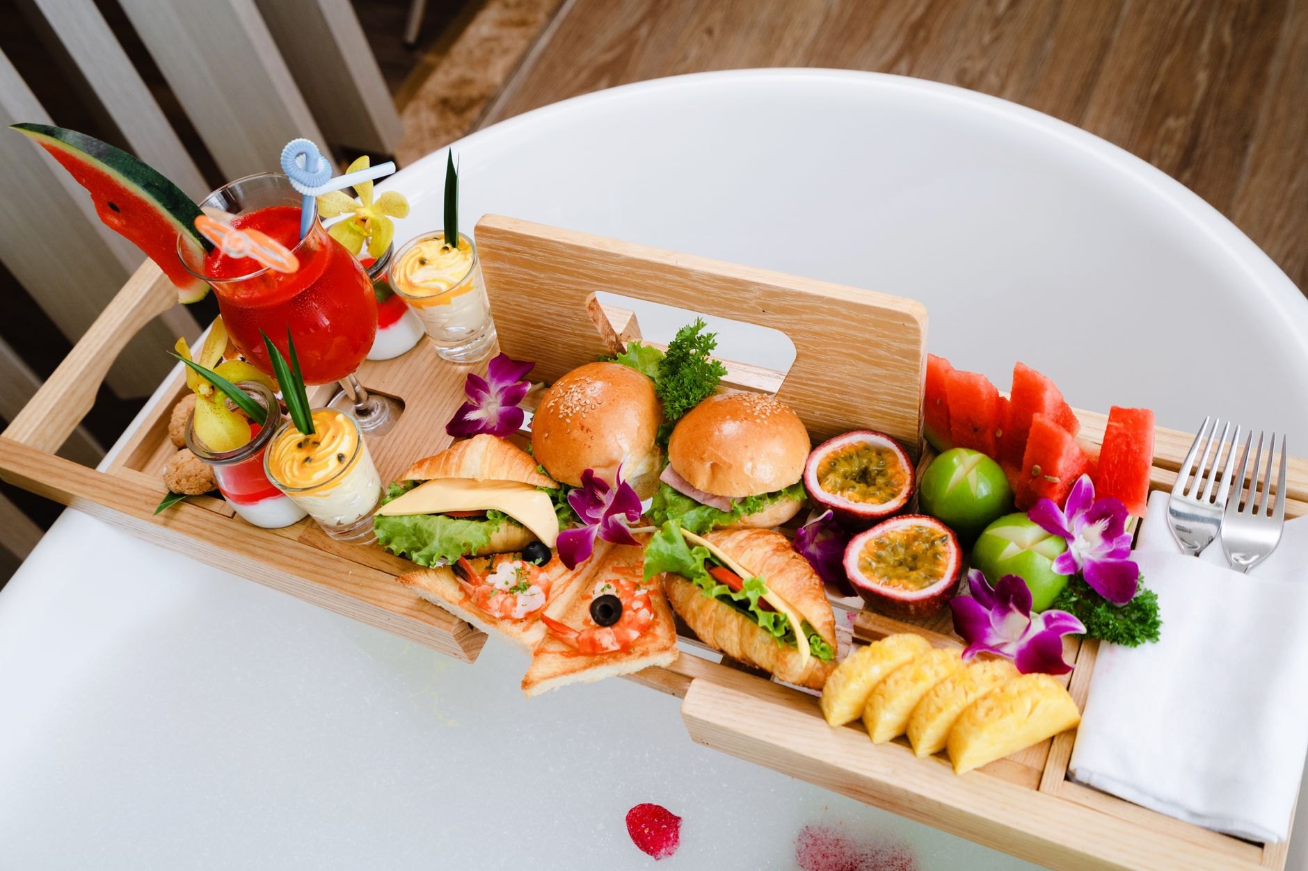 Breakfast tray with pastries, coffee, and fruit arranged naturally